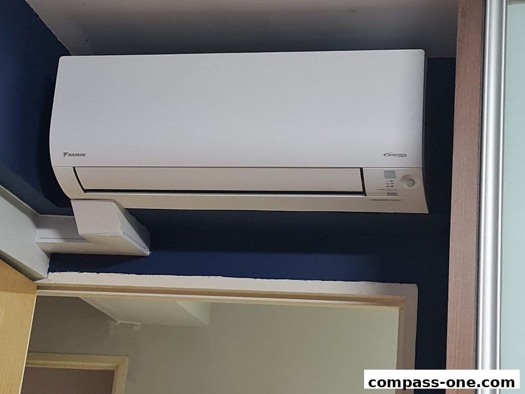 A Daikin air conditioner unit is mounted on a dark blue wall.