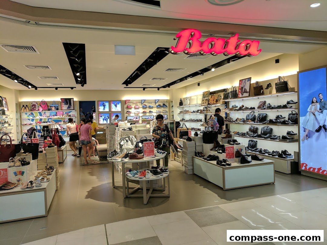 Interior view of a Bata shoe store showcasing a wide variety of footwear and handbags.