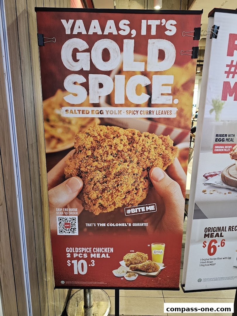 A banner advertising KFC's Gold Spice chicken with salted egg yolk and spicy curry leaves.