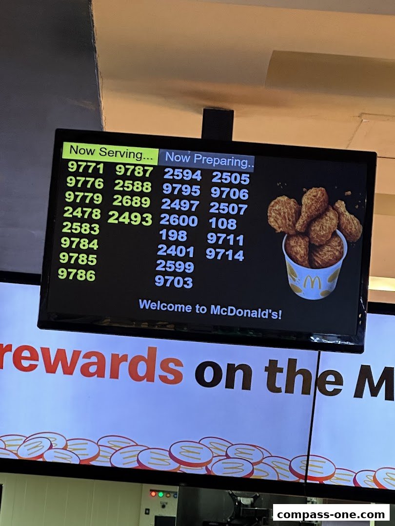 A digital display showing order numbers for 'Now Serving' and 'Now Preparing' at McDonald's.