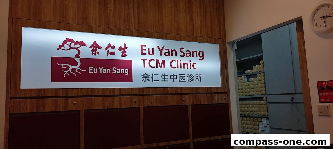 The illuminated sign for Eu Yan Sang TCM Clinic with Chinese characters and a tree logo.