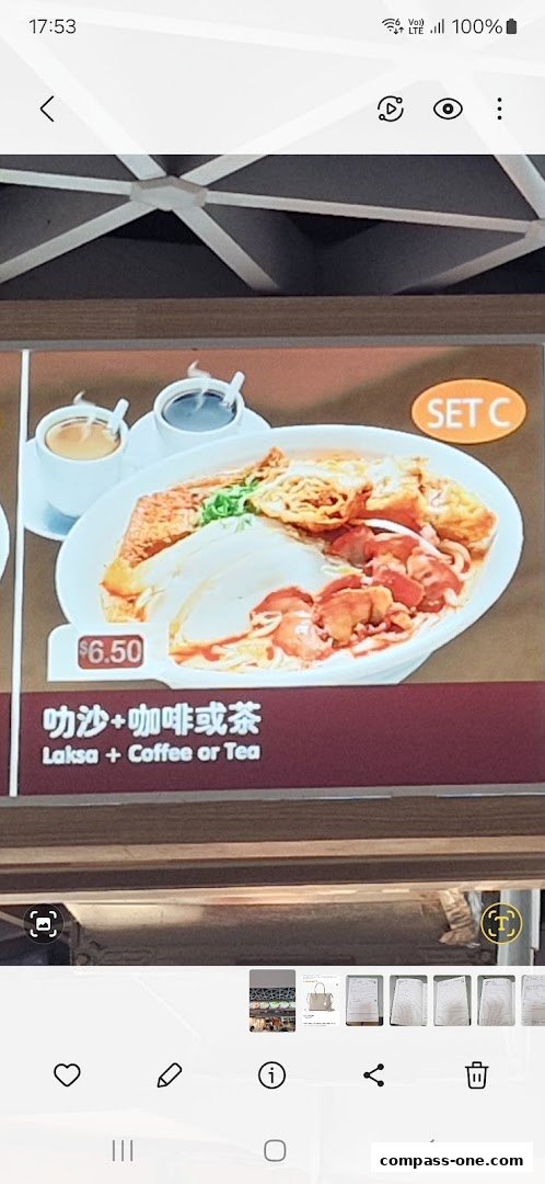A close-up of a menu item showing Laksa with coffee or tea and its price.