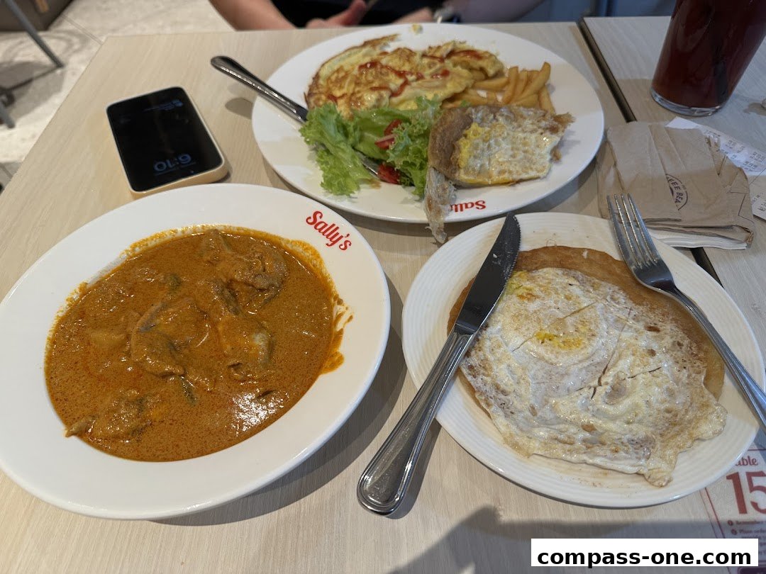 A table with three plates of food, a phone, and a drink.