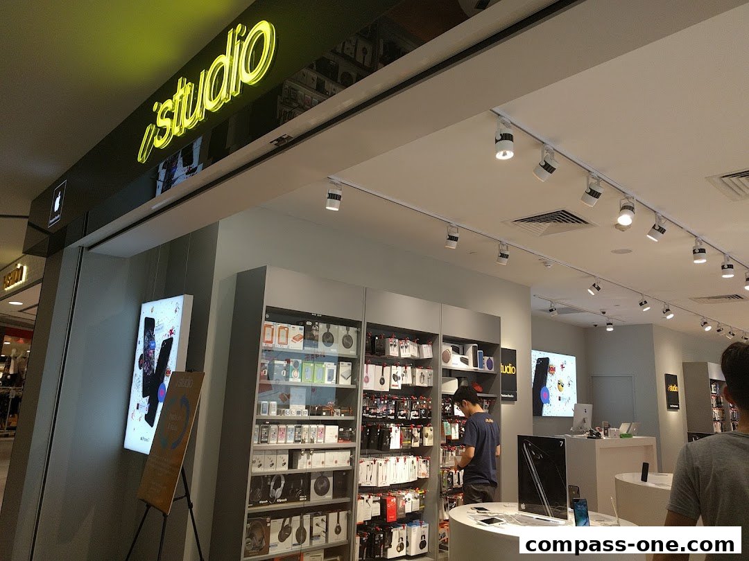 Interior view of an iStudio electronics store showcasing Apple products and accessories.