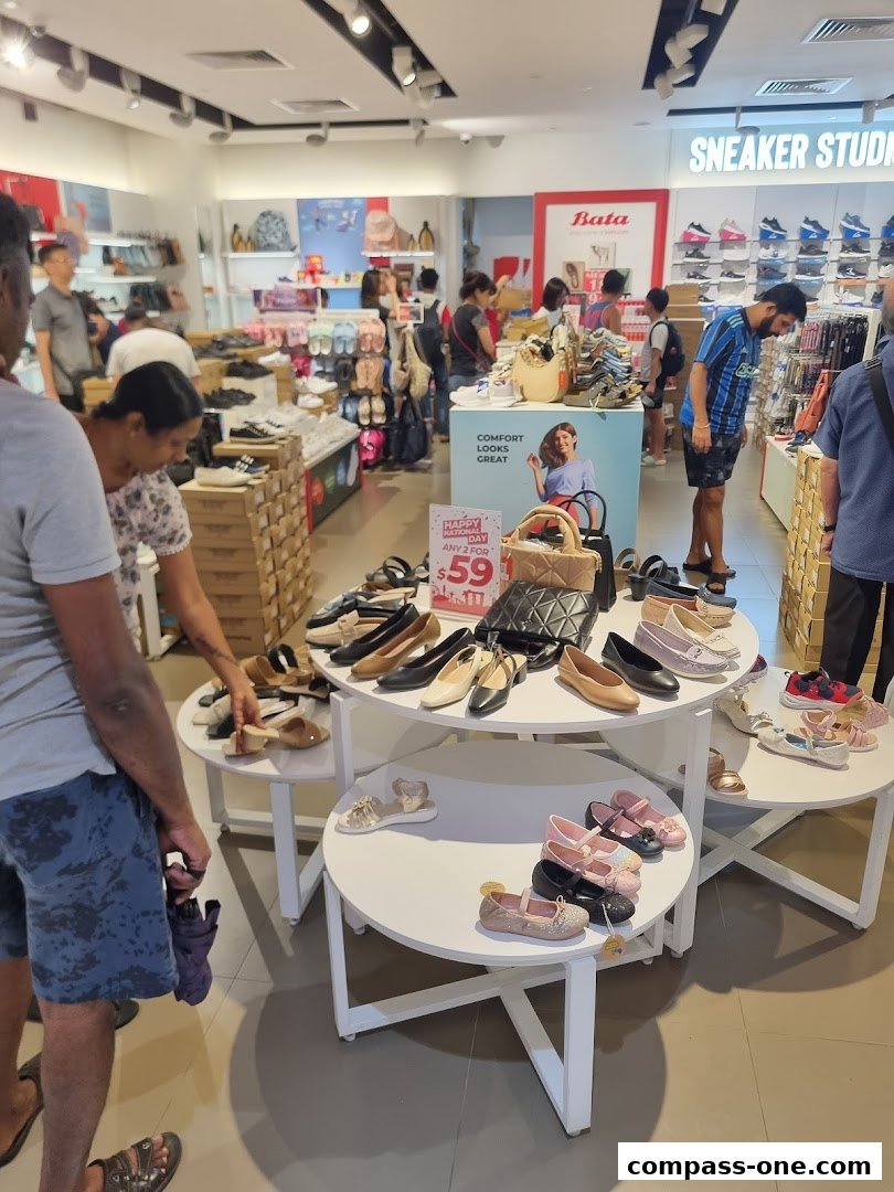 Interior view of a Bata shoe store with various footwear displayed on shelves and tables.