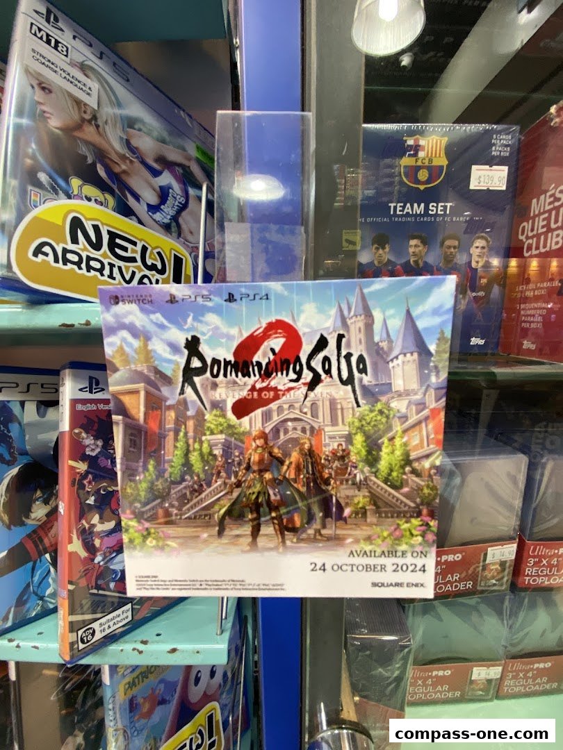 A display of video games and trading cards, featuring 'Romancing SaGa 2' and a Barcelona FC team set.