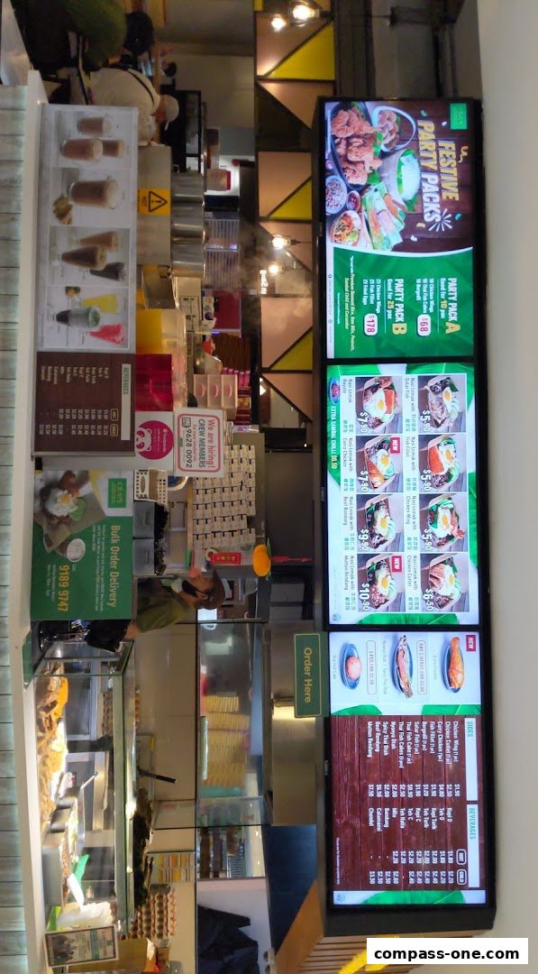A digital menu board displaying various Nasi Lemak dishes and party packs.