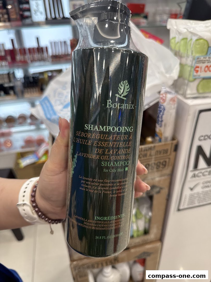 A hand holds a bottle of Botanix Lavender Oil Control Shampoo for Oily Hair.