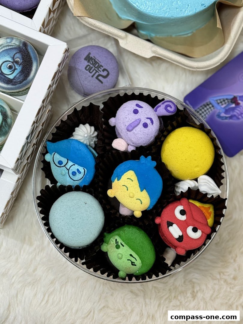A close-up of macarons decorated to resemble characters from the movie Inside Out.