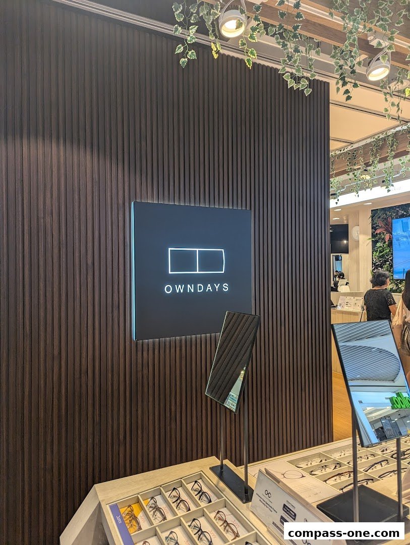 OWNDAYS shop interior with a prominent logo and display of eyeglasses.