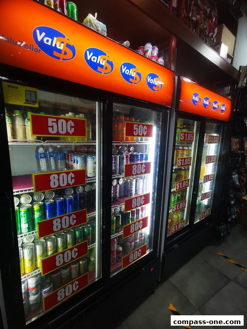 Refrigerated display cases filled with drinks and snacks at Valu.
