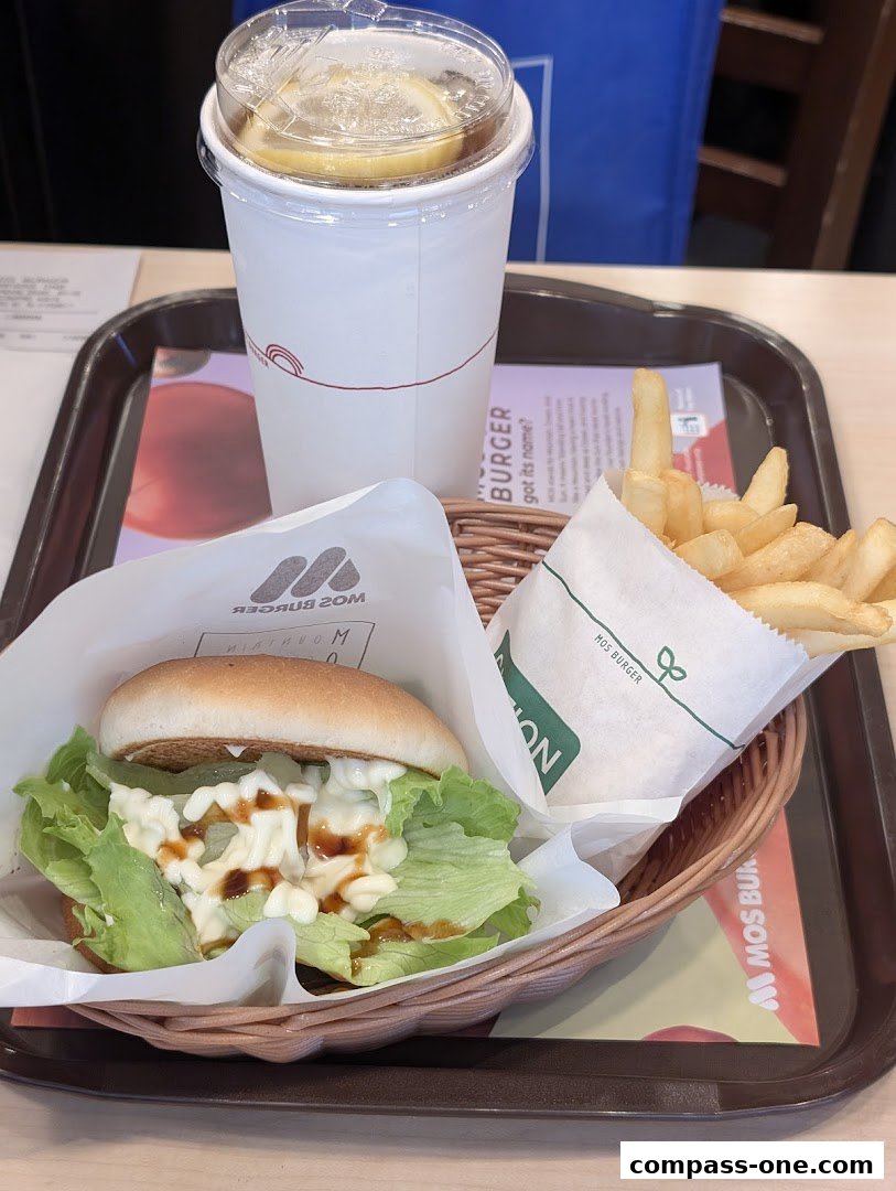 A MOS Burger meal featuring a burger, fries, and a lemon iced tea on a tray.