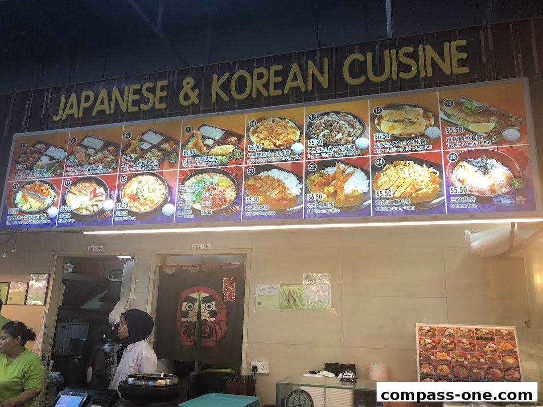 A brightly lit menu board showcasing various Japanese and Korean dishes with prices.