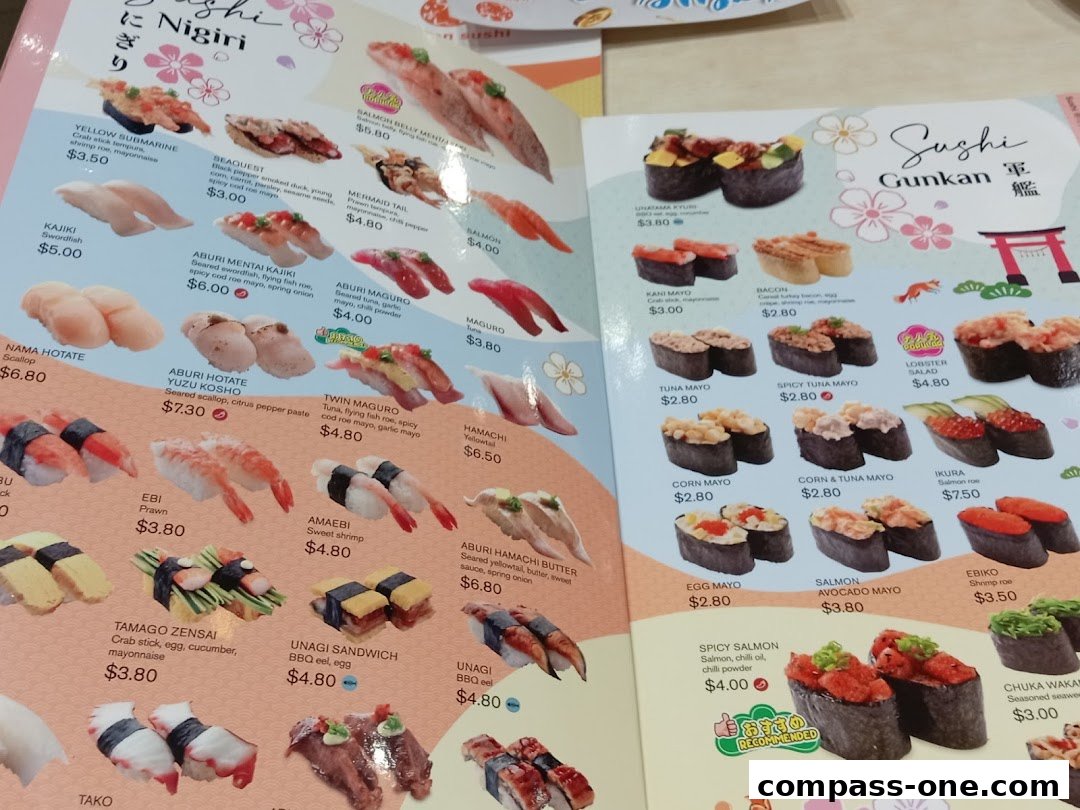 A close-up view of a sushi menu featuring various types of nigiri and gunkan sushi with prices.