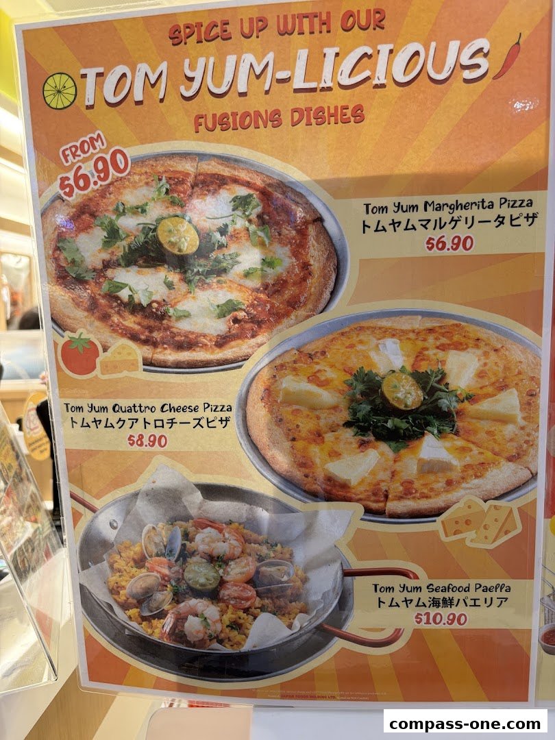 A menu showcasing Tom Yum fusion dishes including pizzas and seafood paella.