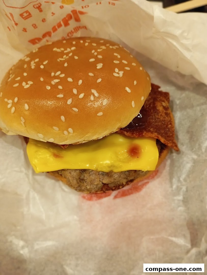 A close-up shot of a delicious Burger King burger with sesame seeds, cheese, and bacon.