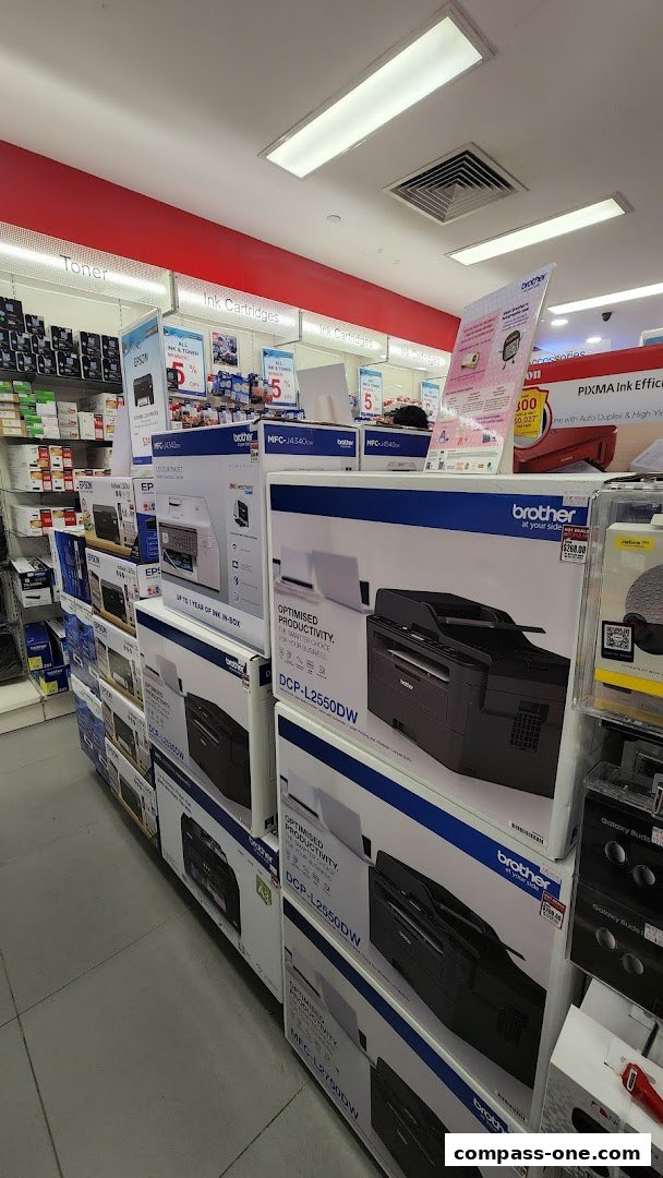 A retail store aisle displaying various Brother printers and ink cartridges.