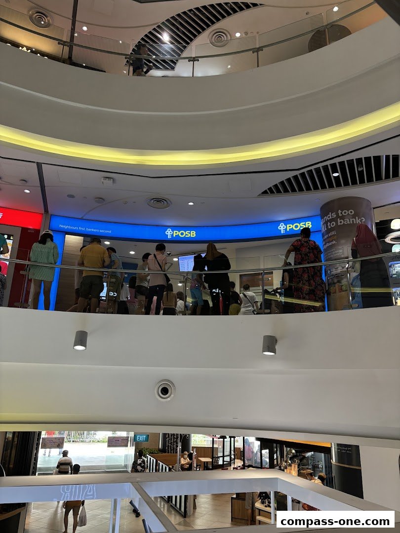 People queuing at the POSB bank branch on the upper level of a shopping mall.
