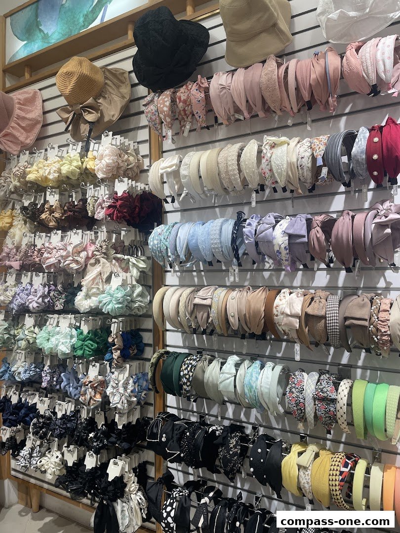 A wall display showcasing a wide variety of hair accessories, including headbands and scrunchies.
