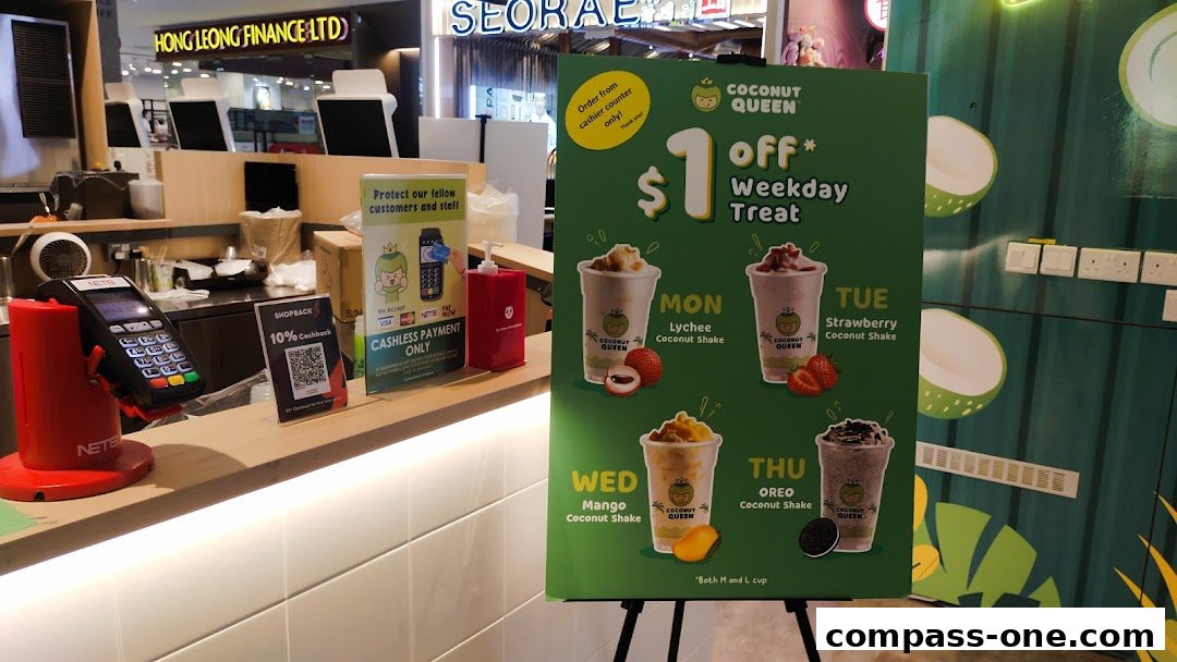 A promotional sign for Coconut Queen offering $1 off weekday treats with various coconut shakes.
