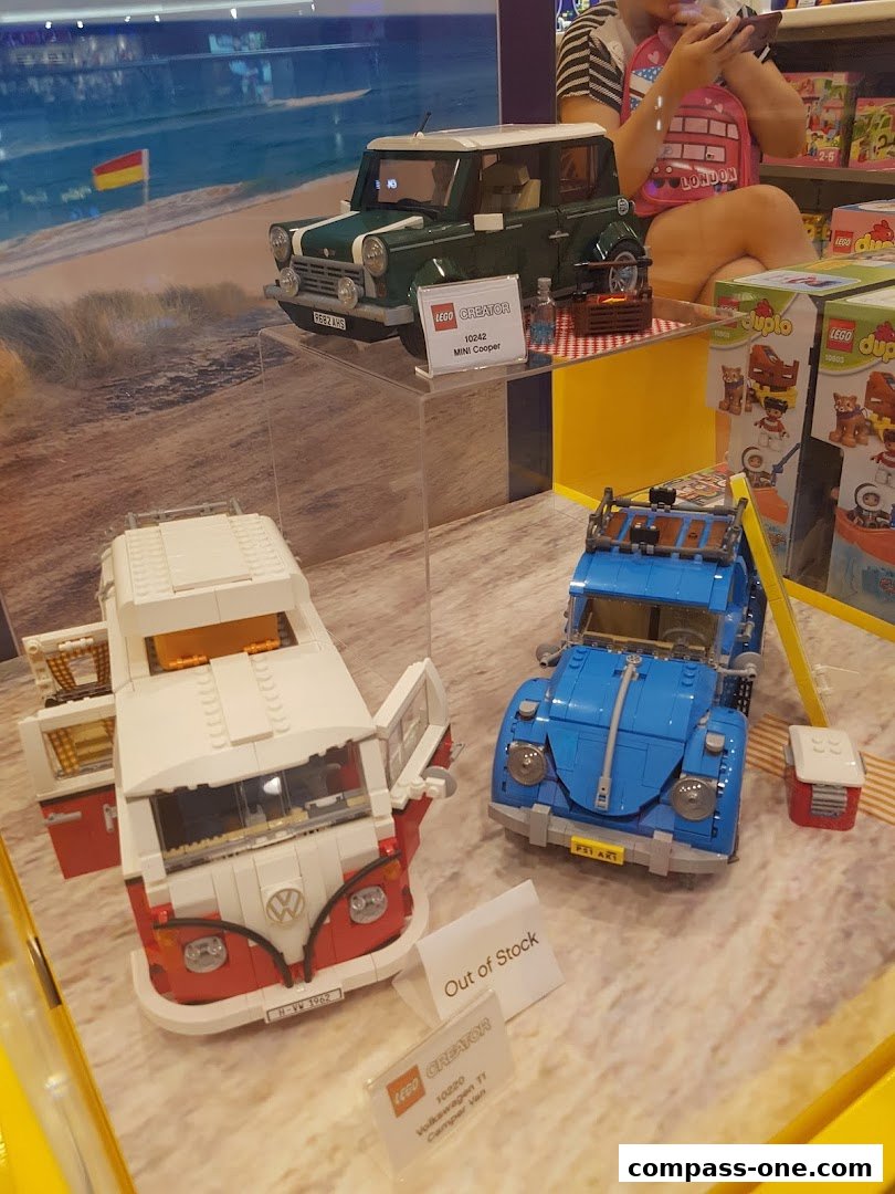 LEGO Creator car models displayed in a shop window, including a Mini Cooper and Volkswagen van.