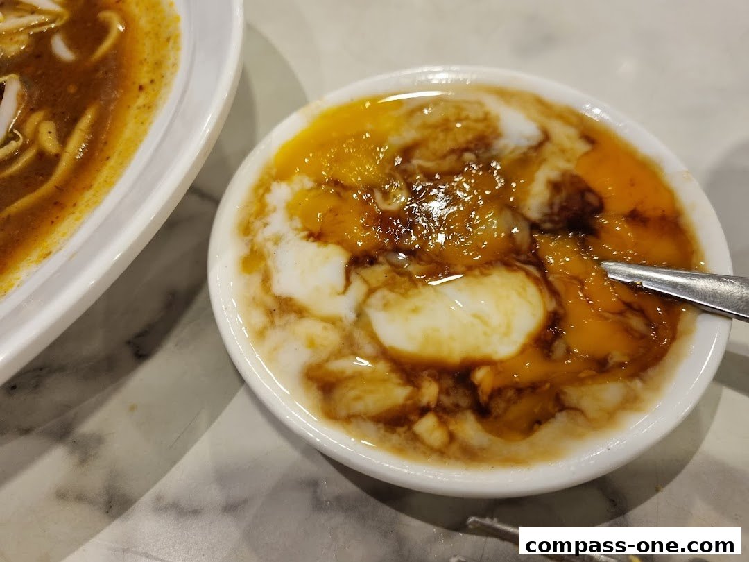 A close-up of soft-boiled eggs with soy sauce and pepper, served in a white bowl.