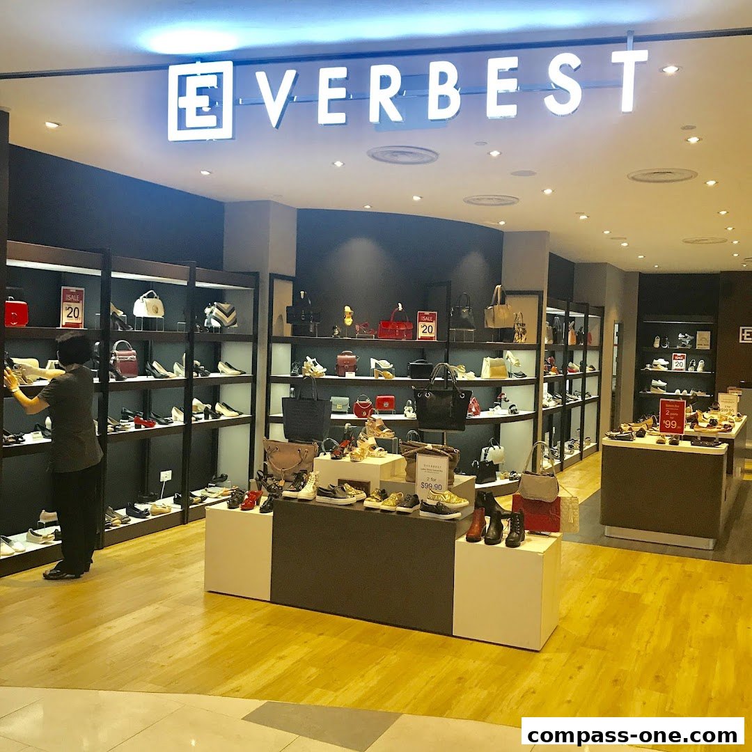 A well-lit shoe and handbag store with a wide selection of products displayed on shelves and stands.