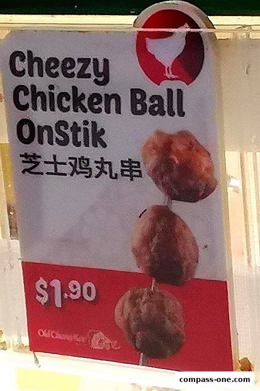 A sign advertising Cheezy Chicken Ball OnStik from Old Chang Kee for $1.90.