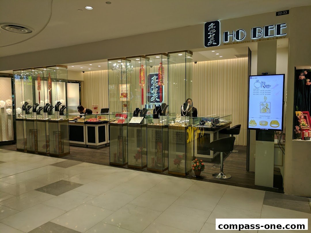 Ho Bee Goldsmith & Jewellery shop front with display cases and staff.