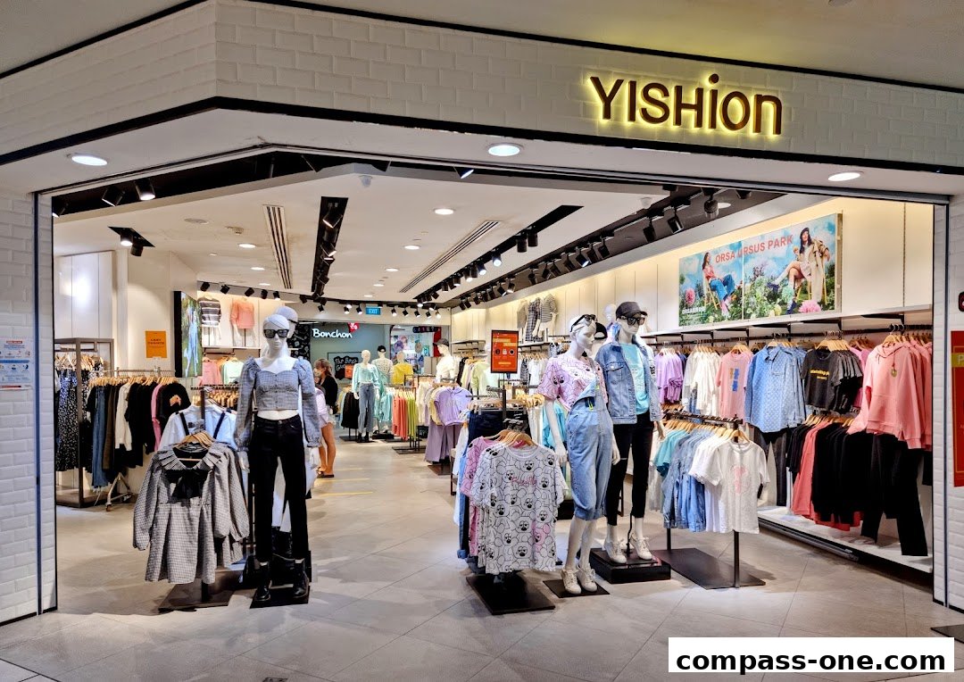 A YISHION clothing store interior with mannequins displaying trendy outfits and racks of apparel.