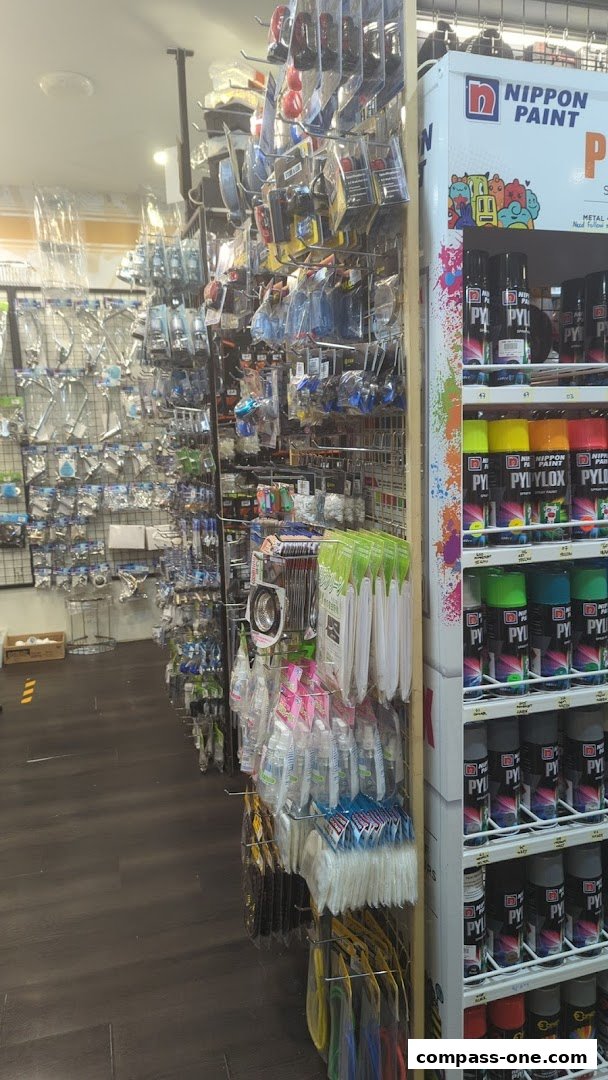 Interior view of a shop displaying various household and hardware items on shelves and racks.