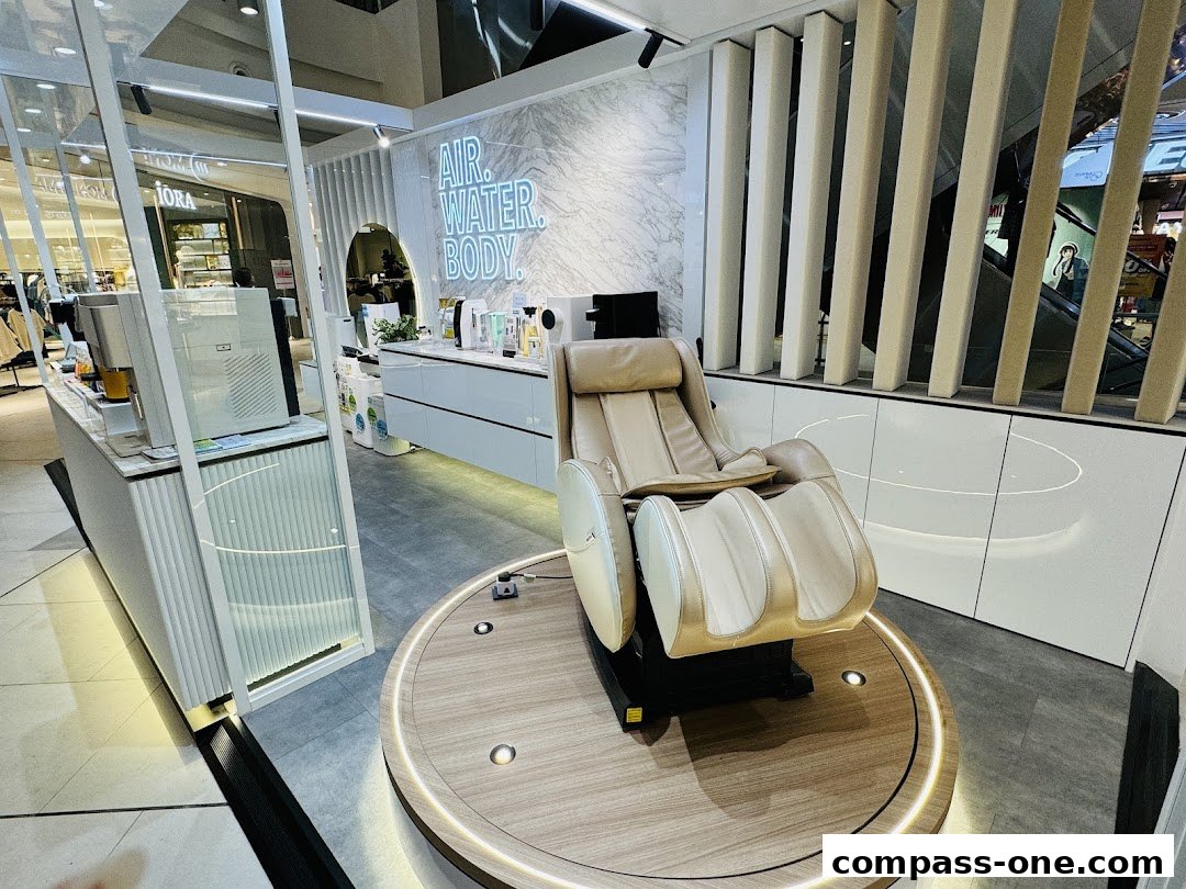 A modern retail space featuring a massage chair and products with 'AIR. WATER. BODY.' signage.
