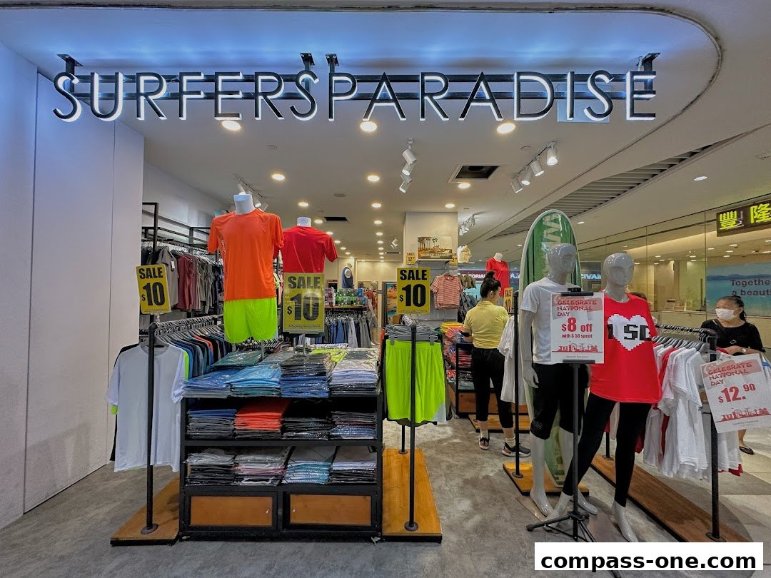 Surfers Paradise shop front displaying apparel on mannequins and racks, with sale signs.