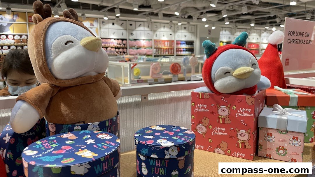 Cute Christmas-themed plush toys and gift boxes displayed in a retail store.