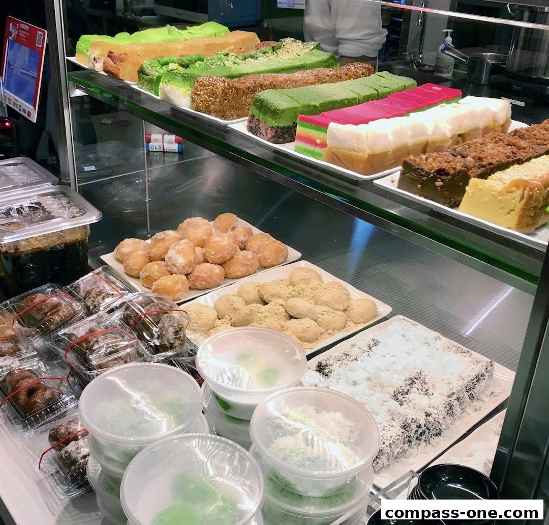 A display case filled with various colorful cakes, pastries, and desserts.