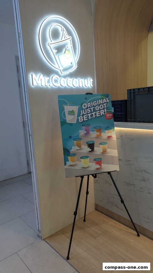 Mr. Coconut shop entrance with a display board showcasing various new drinks.