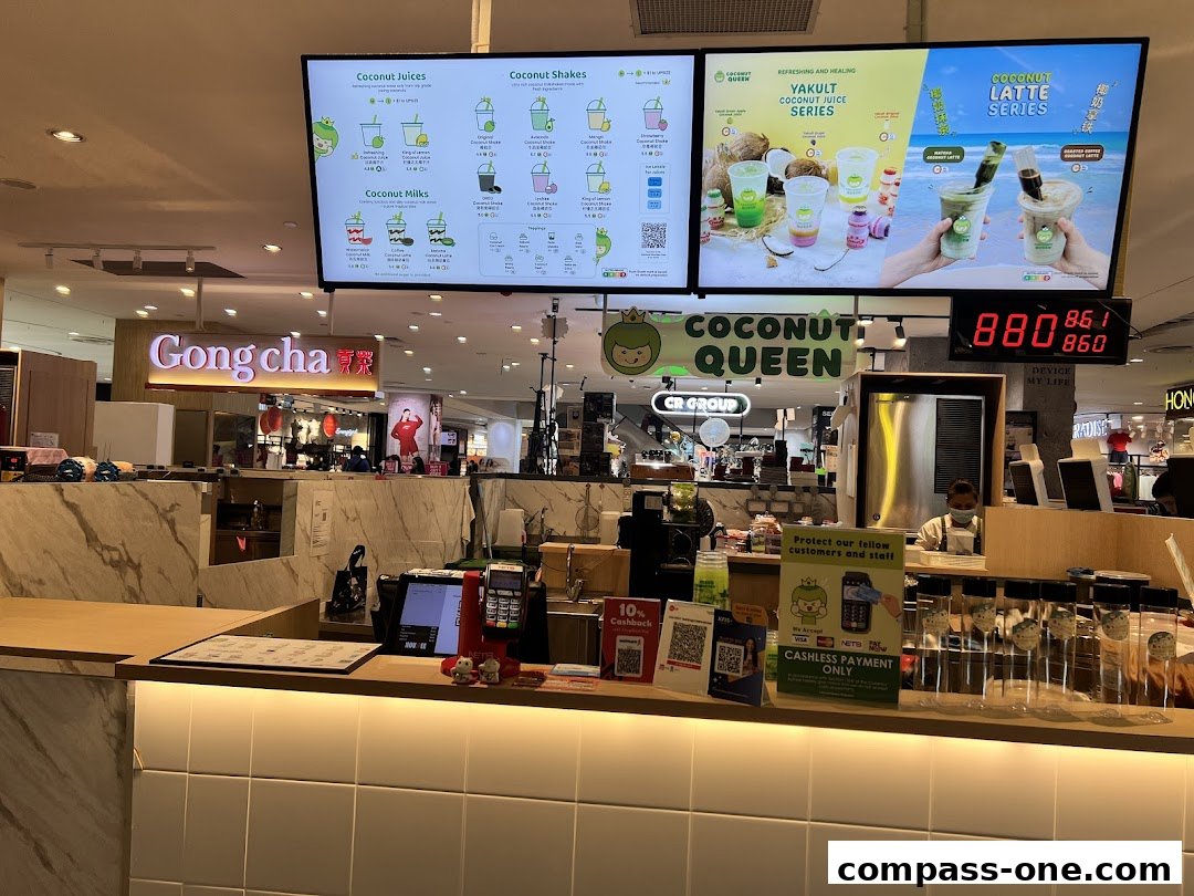 A menu board displaying various coconut juice, shake, and latte options at Coconut Queen.