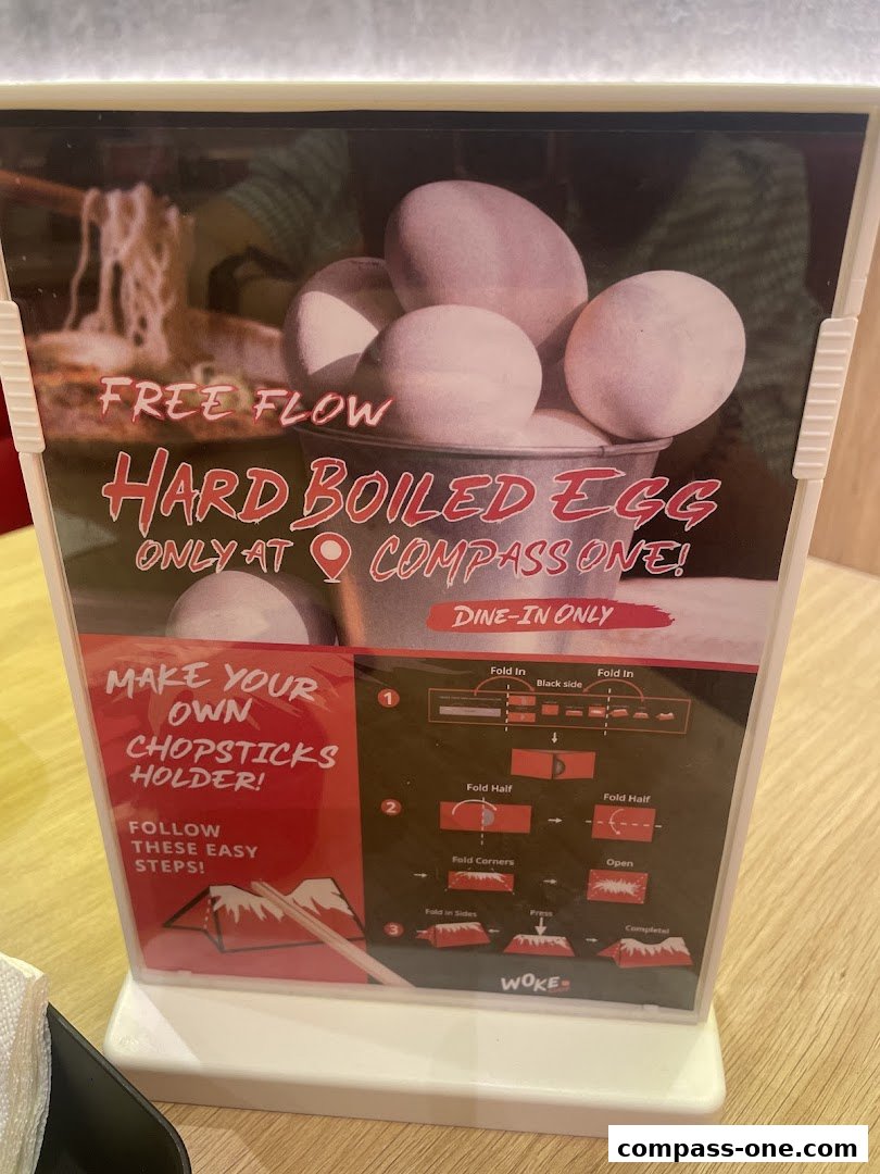 A sign advertising free flow hard-boiled eggs and instructions for making a chopsticks holder.