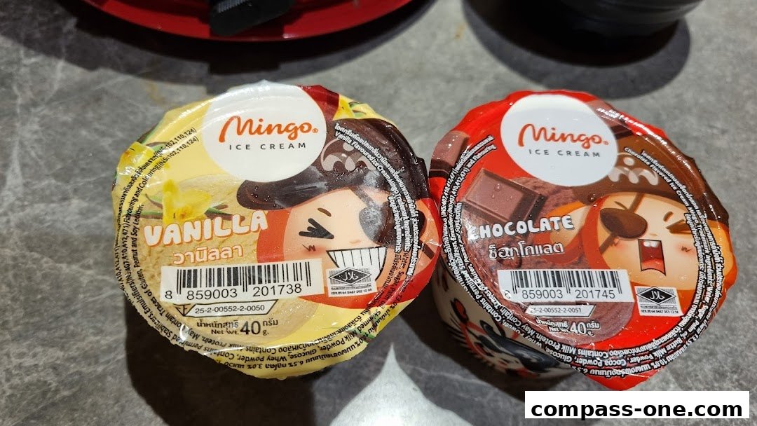 Two cups of Mingo Ice Cream, one vanilla and one chocolate, with cartoon pirate characters.