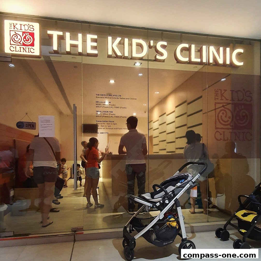 The entrance of 'The Kid's Clinic' with people inside and strollers outside.