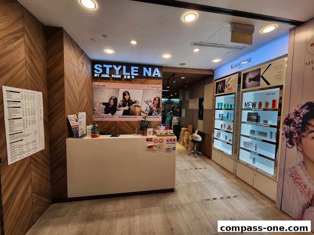 The interior of a hair salon with a reception desk, product displays, and a menu board.