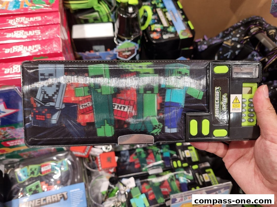 A hand holds a Smiggle pencil case featuring Minecraft characters and a calculator.