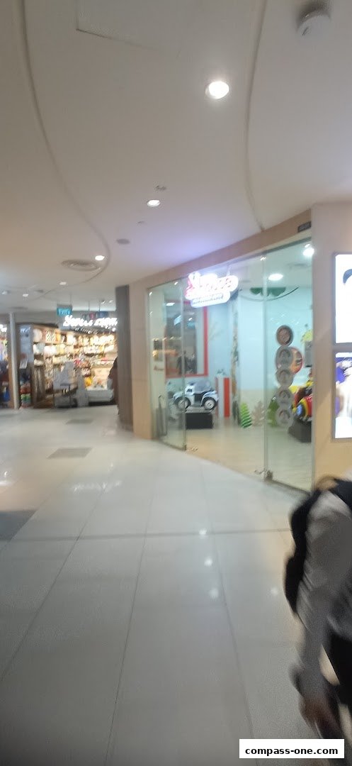 The entrance to Okinawa Hair Salon, featuring a glass facade and a child-friendly car seat.
