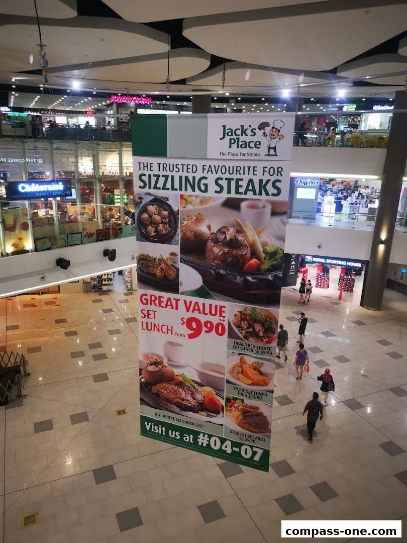 A large banner for Jack's Place restaurant advertising sizzling steaks and set lunches.