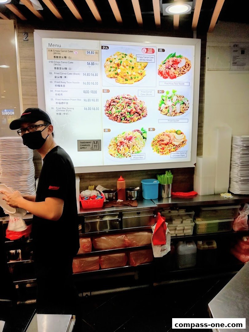A menu board displaying various noodle and cake dishes with prices and images.