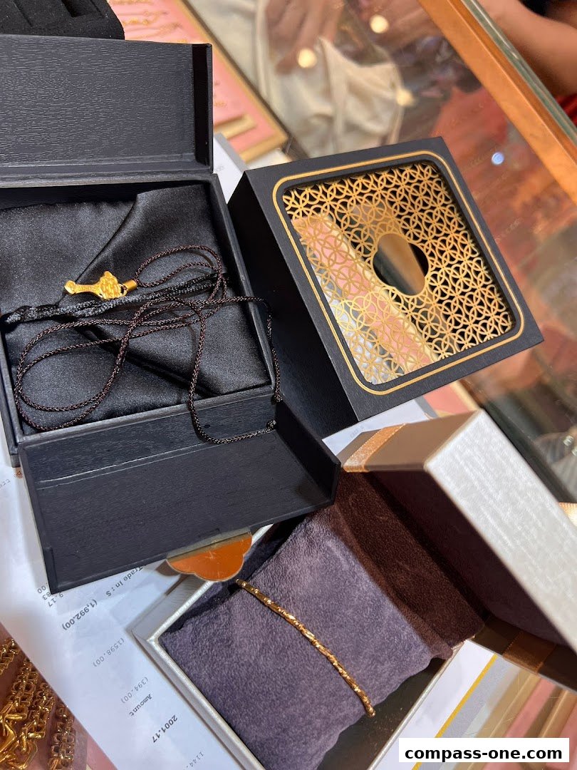 Gold jewelry pieces displayed in elegant gift boxes, suggesting luxury and fine craftsmanship.