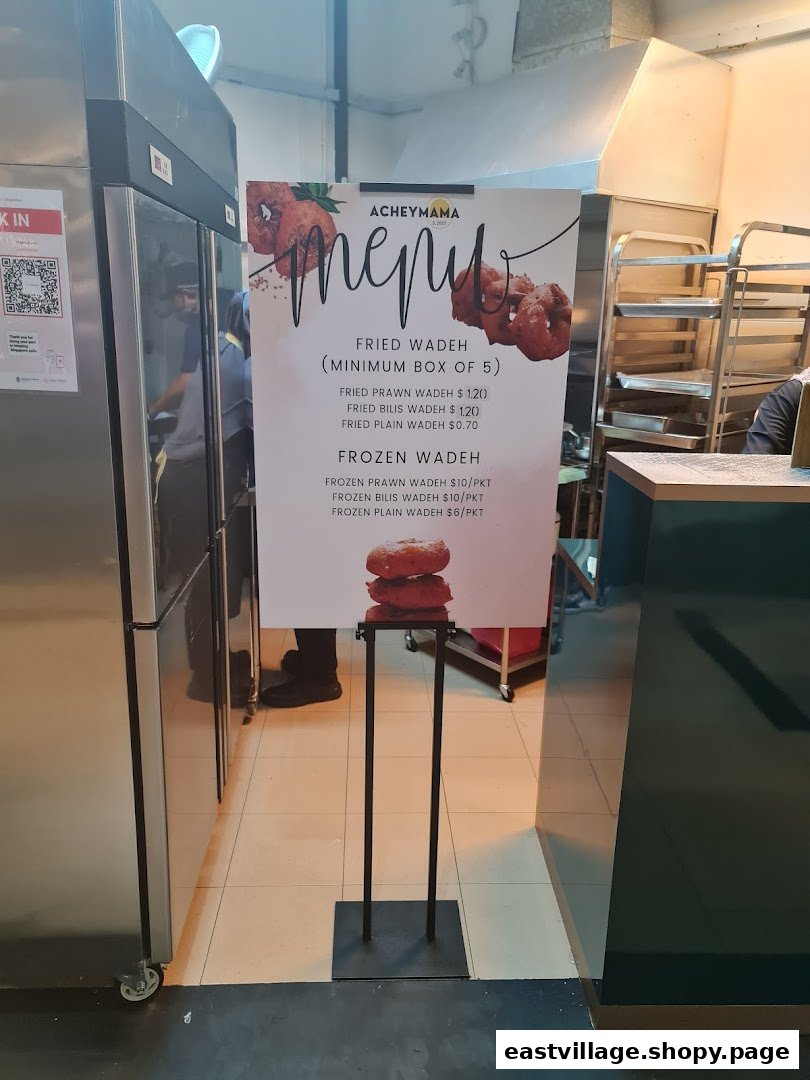Acheymama's menu stand displaying prices for fried and frozen wadeh.