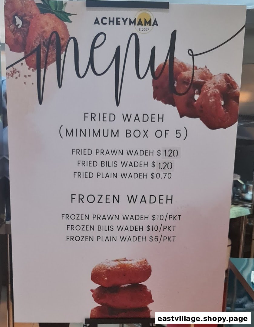 Acheymama's menu board displaying prices for fried and frozen wadeh snacks.