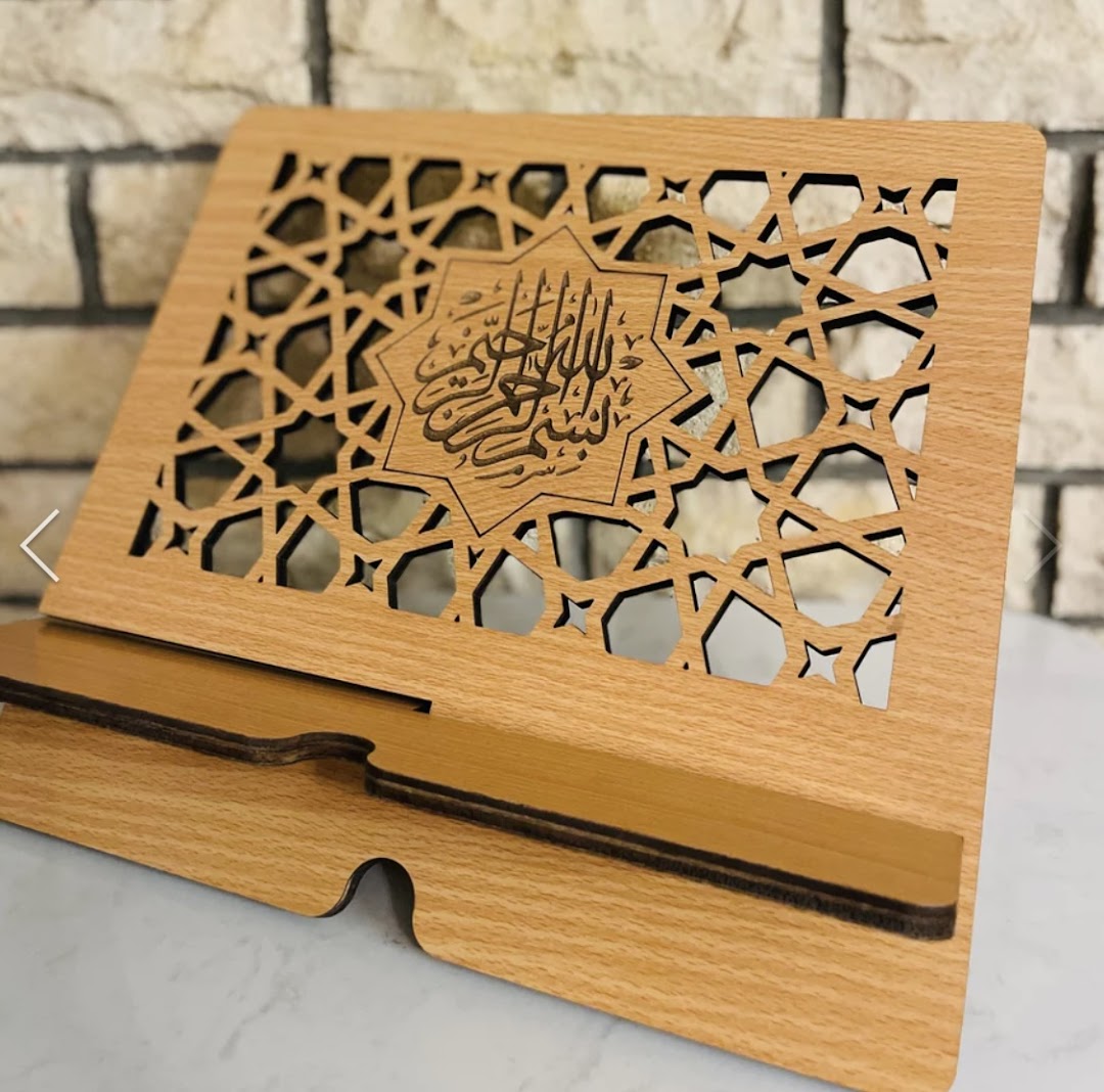 A beautifully crafted wooden Quran stand featuring intricate Islamic geometric patterns and calligraphy.