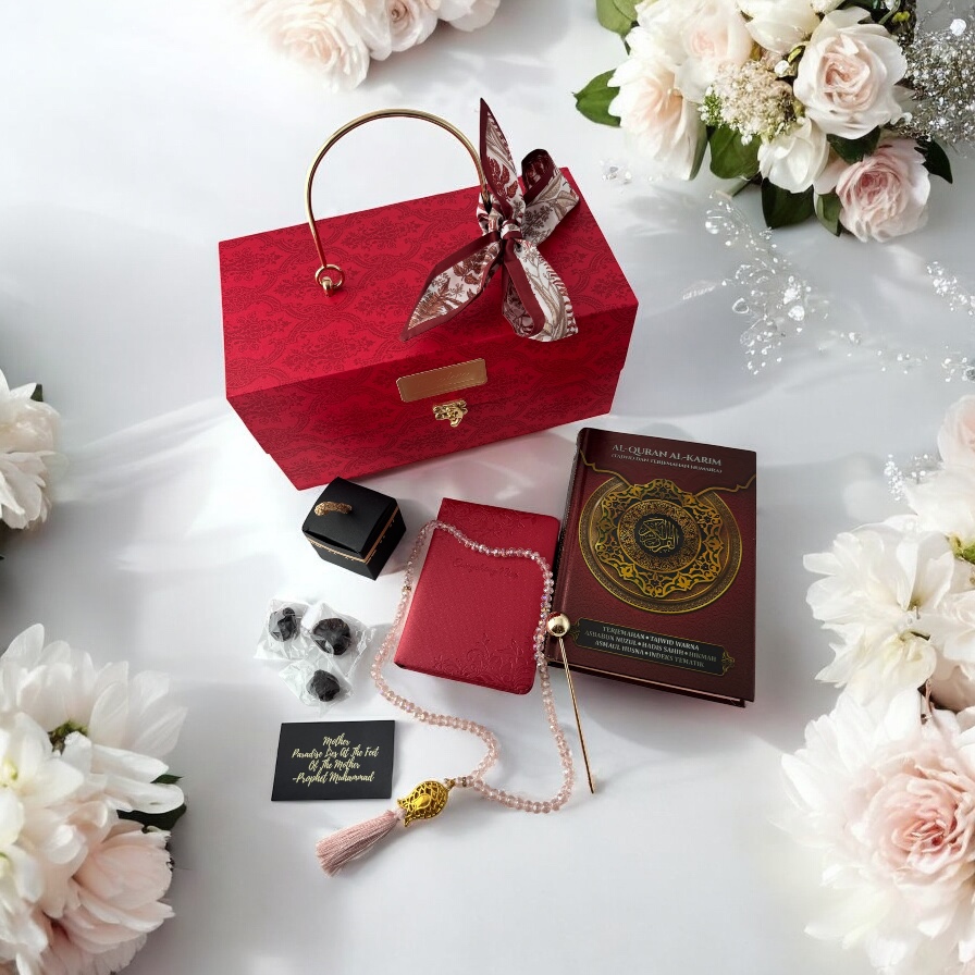 A luxurious Islamic gift set featuring a Quran, prayer beads, and dates, elegantly presented with flowers.